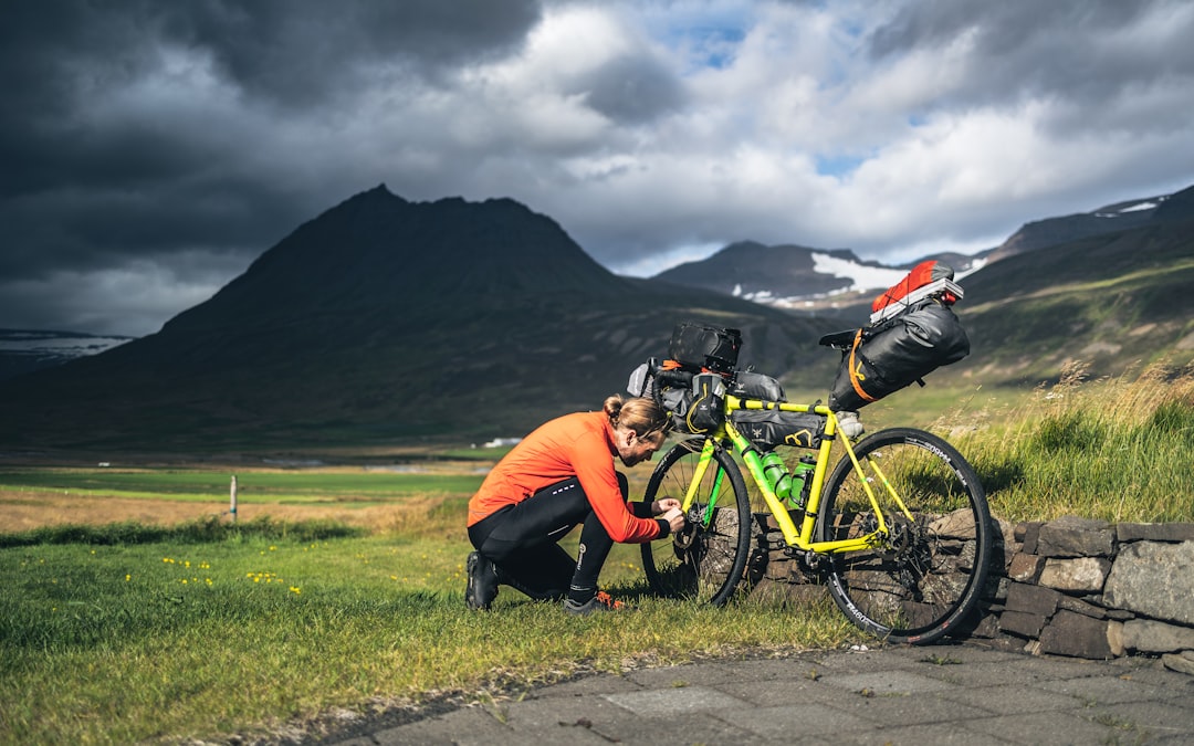 a man kneeling down next to a bike